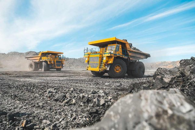 Large quarry dump truck. Loading the rock in dumper. Loading coal into body truck. Production useful minerals. Mining truck mining machinery, to transport coal from open-pit as the Coal Production